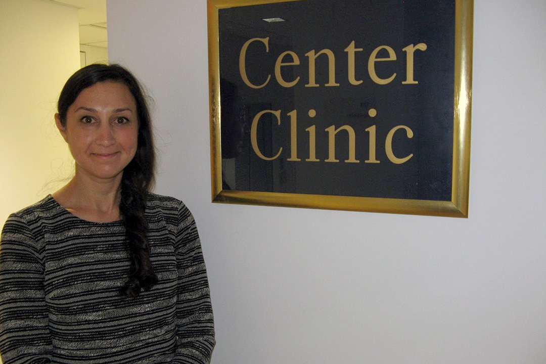 Mollie Dee standing outside the Center Clinic sign