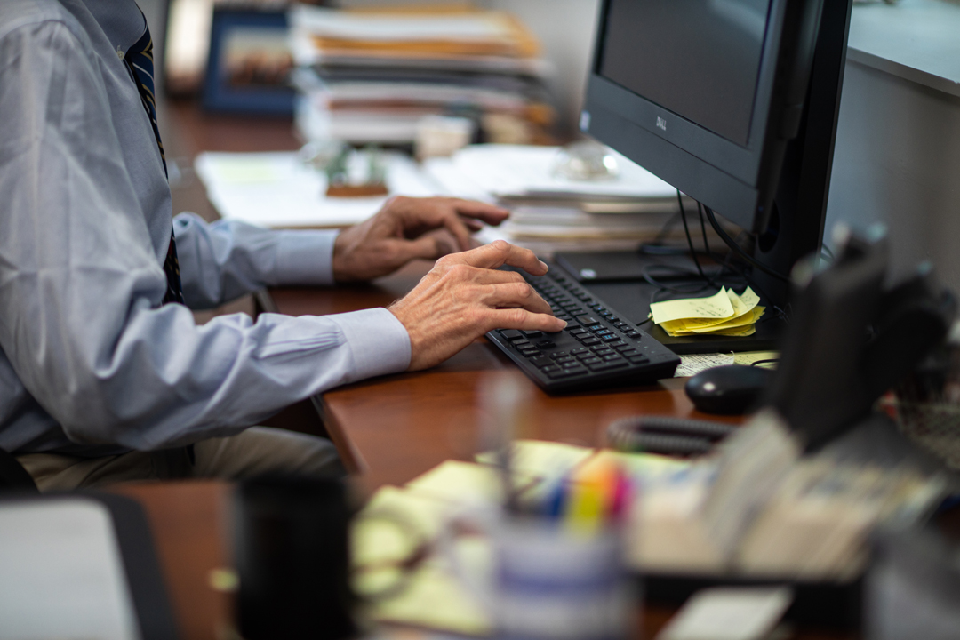hands typing on a computer keyboard