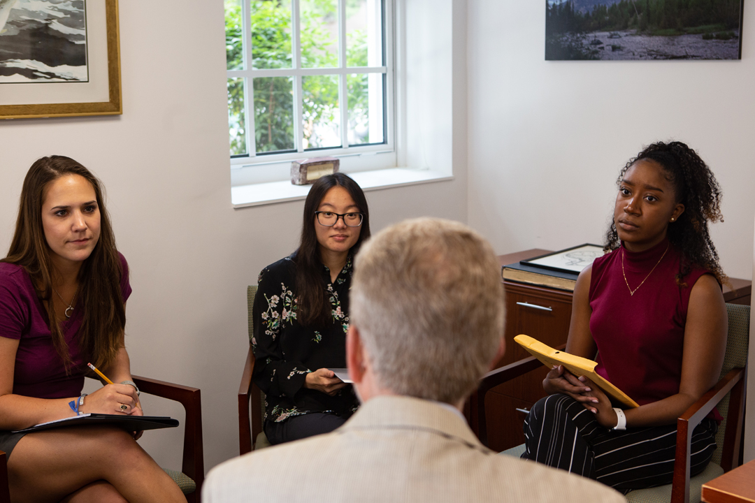 3 Professional Psychology students speaking with Loring Ingram